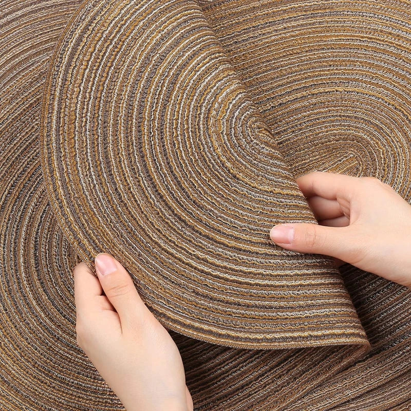 Oversized oval hand-braided woven table mat leaning against a linen drape