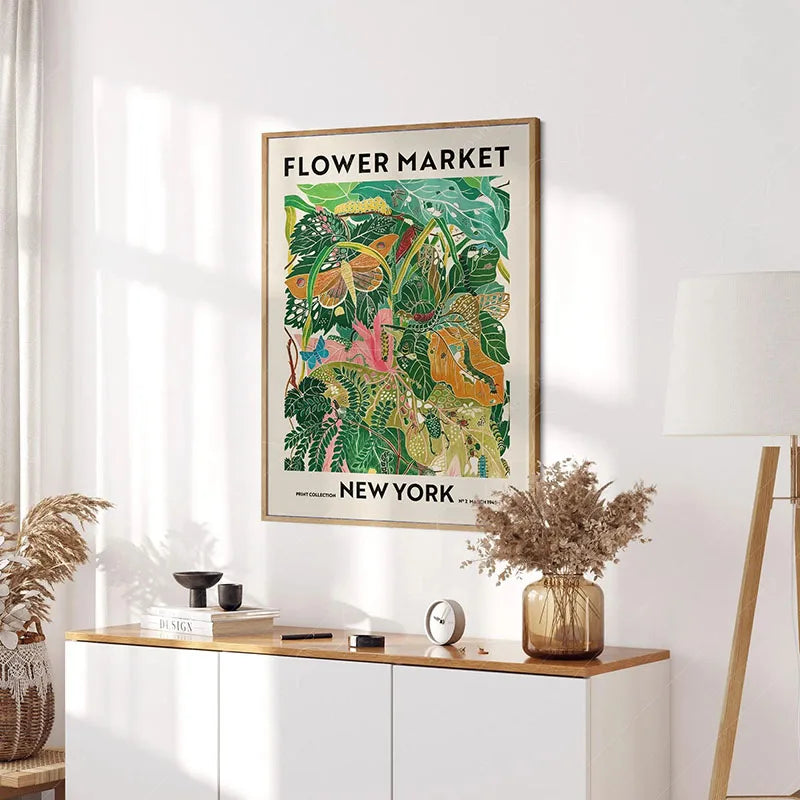 Monstera leaf canvas print framed above a mid-century wooden console table