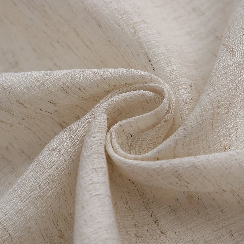 Close-up of woven linen texture and handcrafted tassel trim