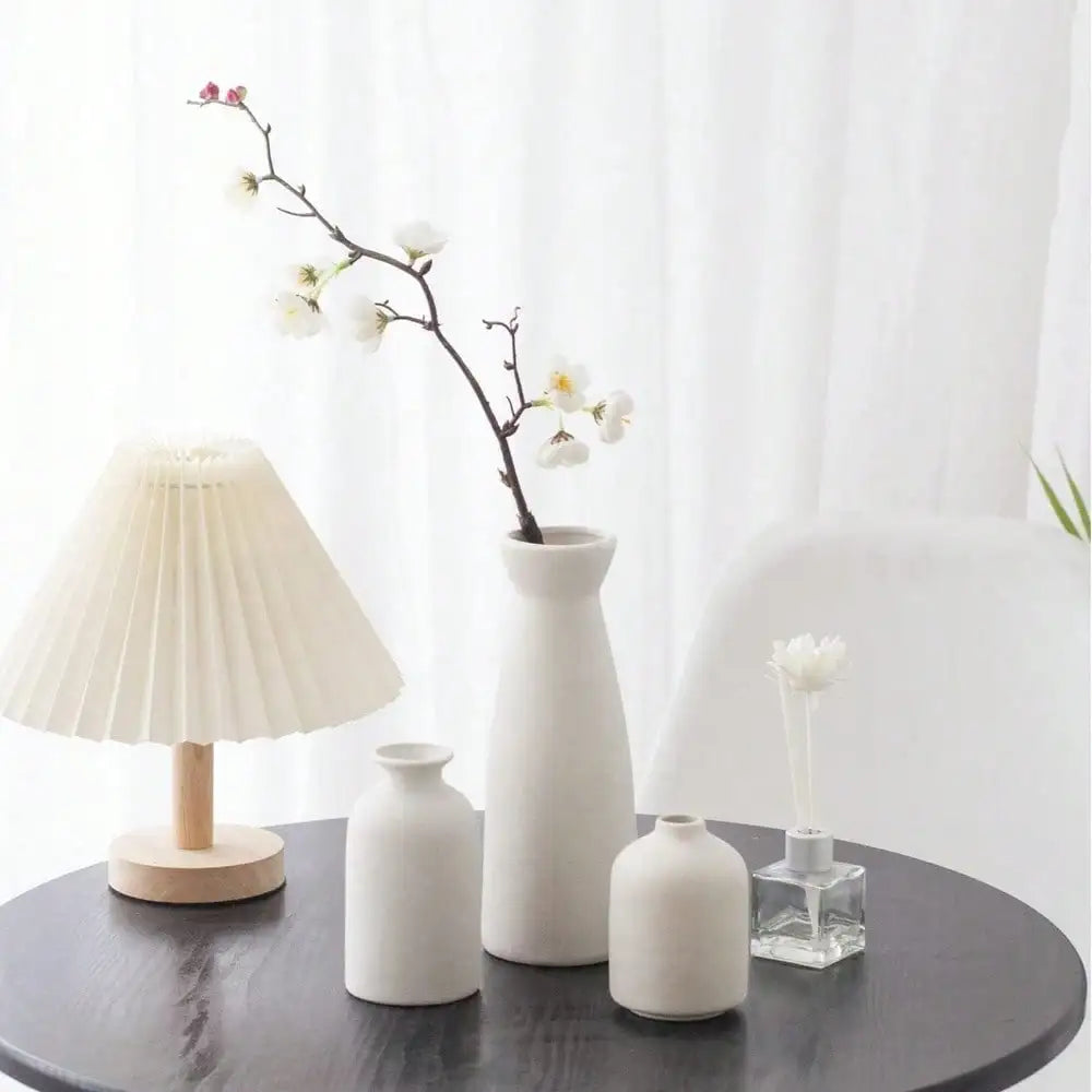 Two ceramic vases styled on a rustic wooden console against a concrete wall