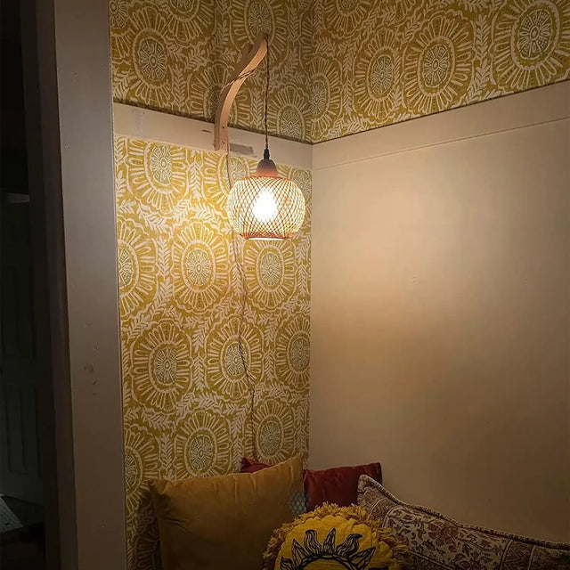 Lamp glowing in a foyer by an entryway mirror